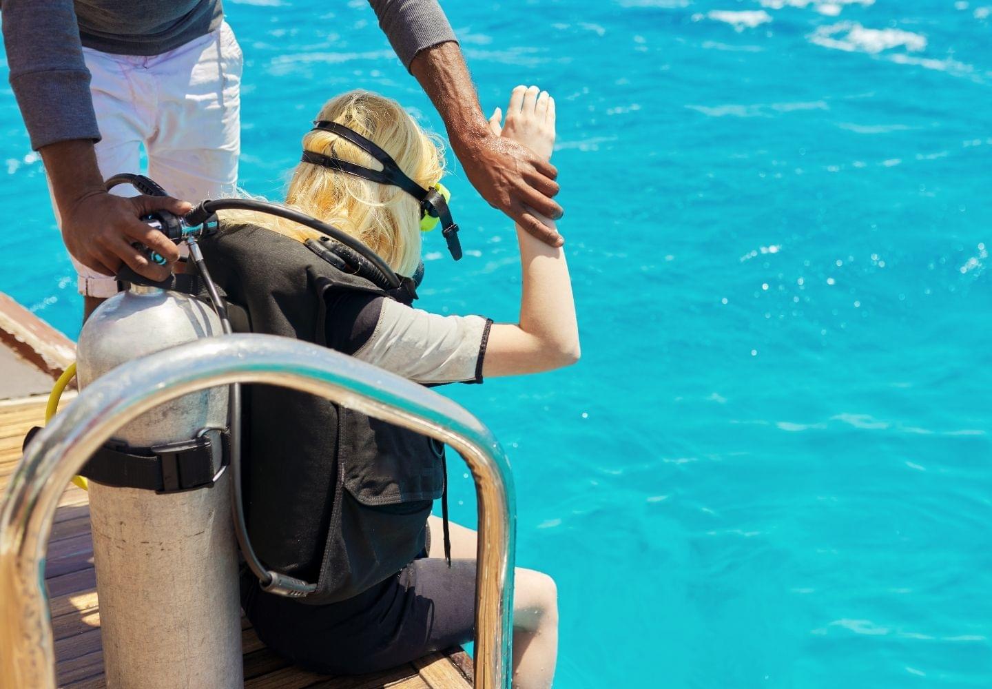 girl preparing for dive with instructor