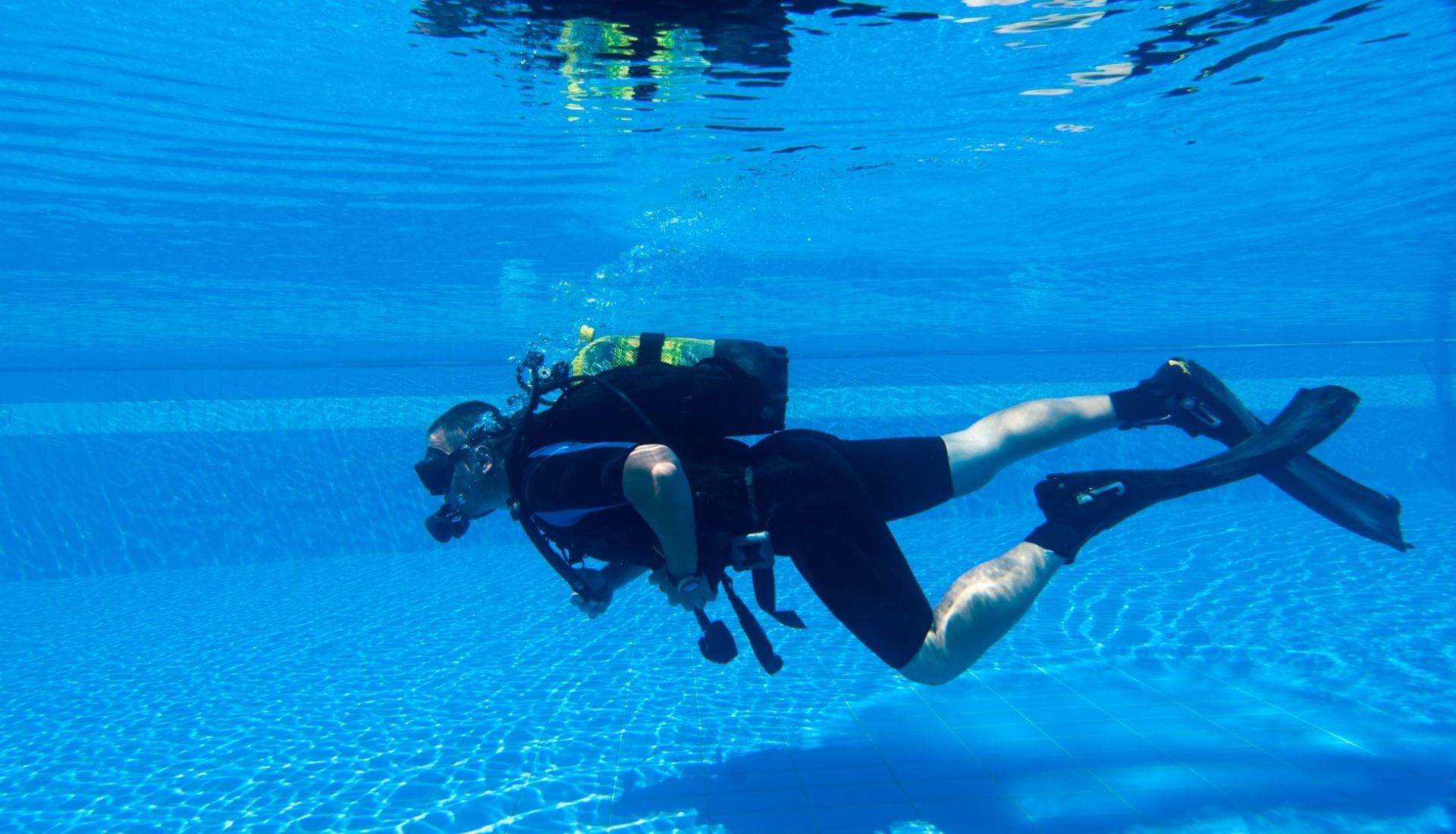 scuba diver practicing in pool