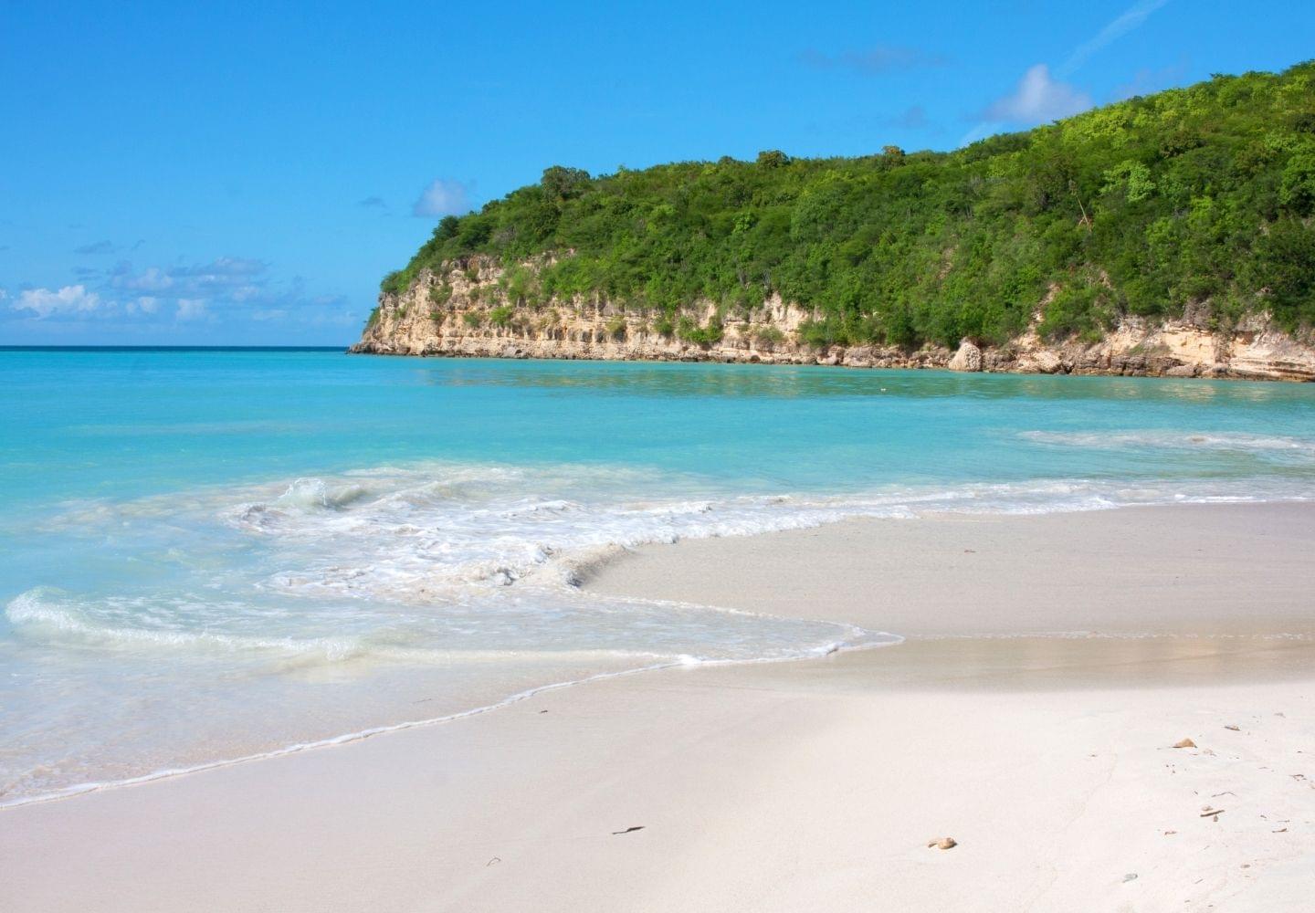 dickenson bay beach and cliffs