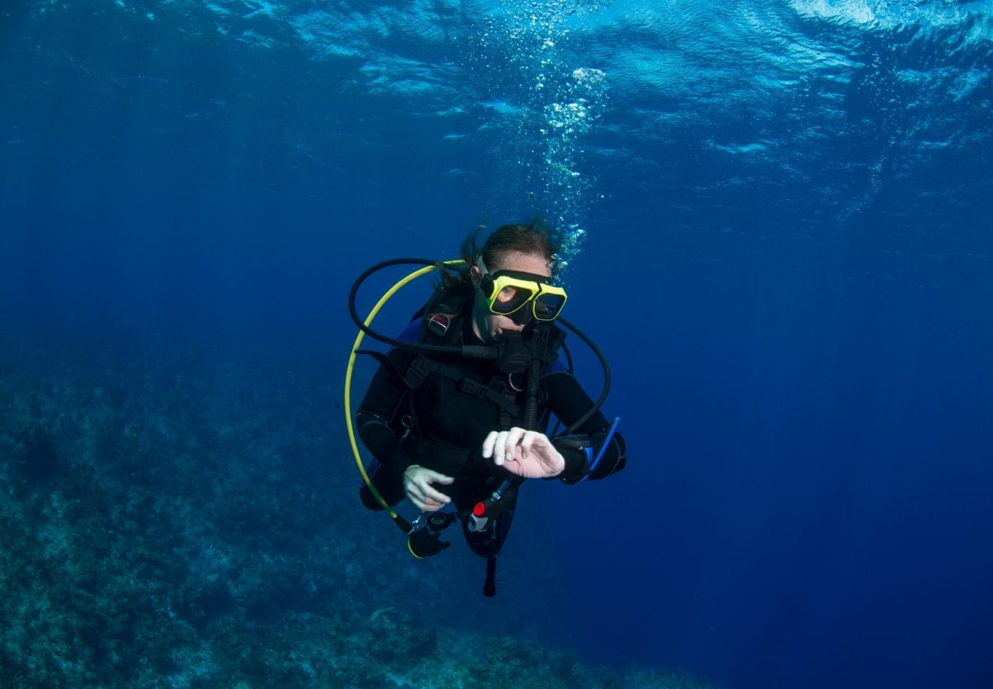 scuba diving underwater checking dive computer