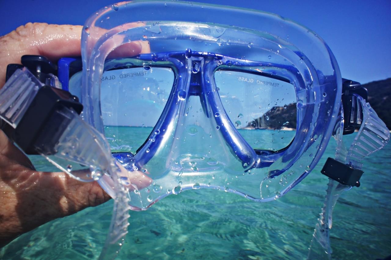Holding up snorkel mask to face