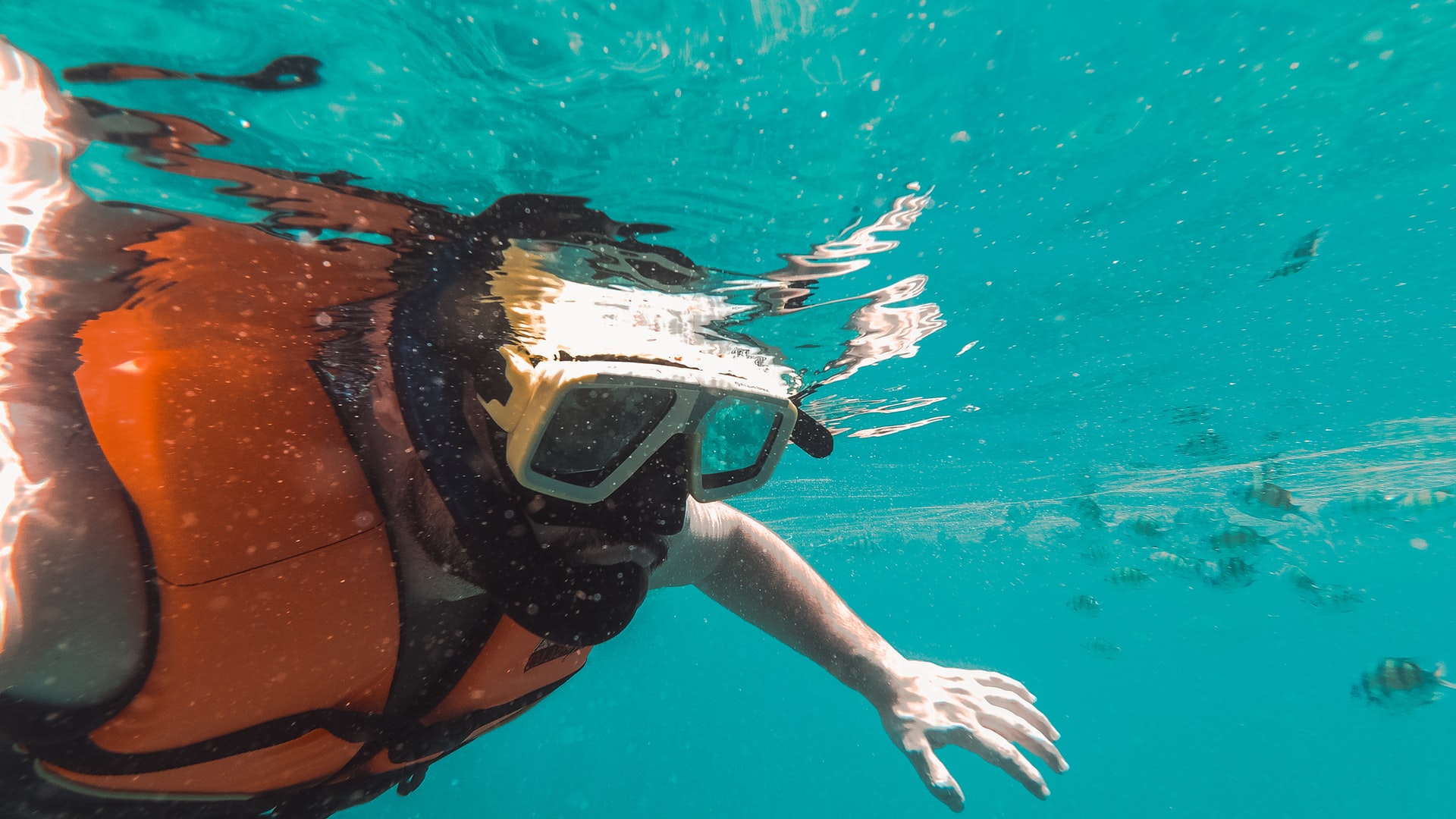 A foam life jacket floats you, but it pushes back when you put your face down A snorkeler floating face down in an orange foam life jacket