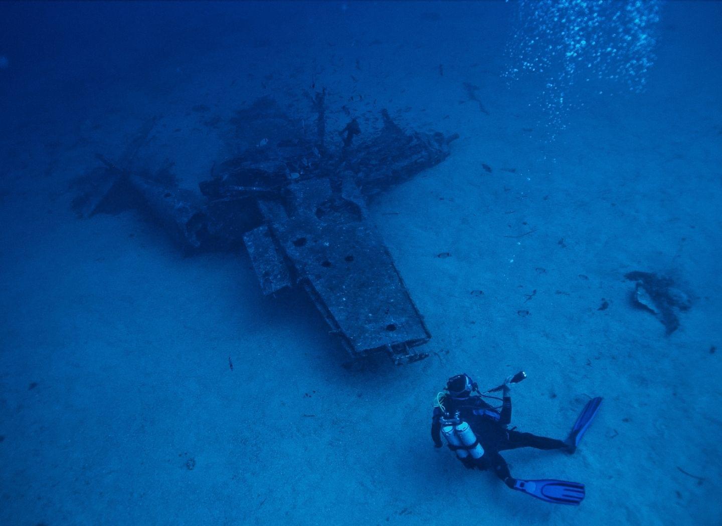 scuba diver diving a plane wreck