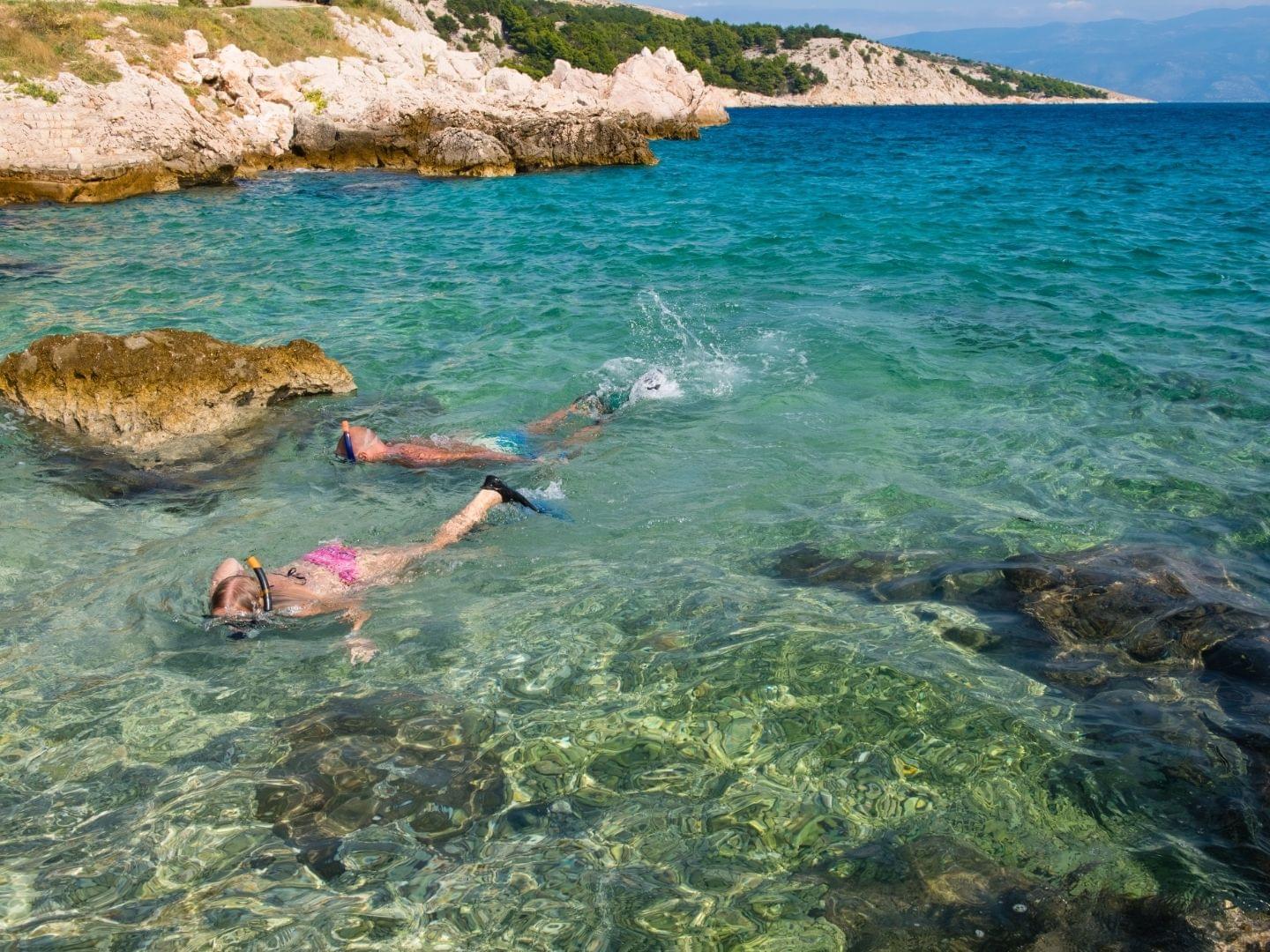 snorkeling around rocky beach