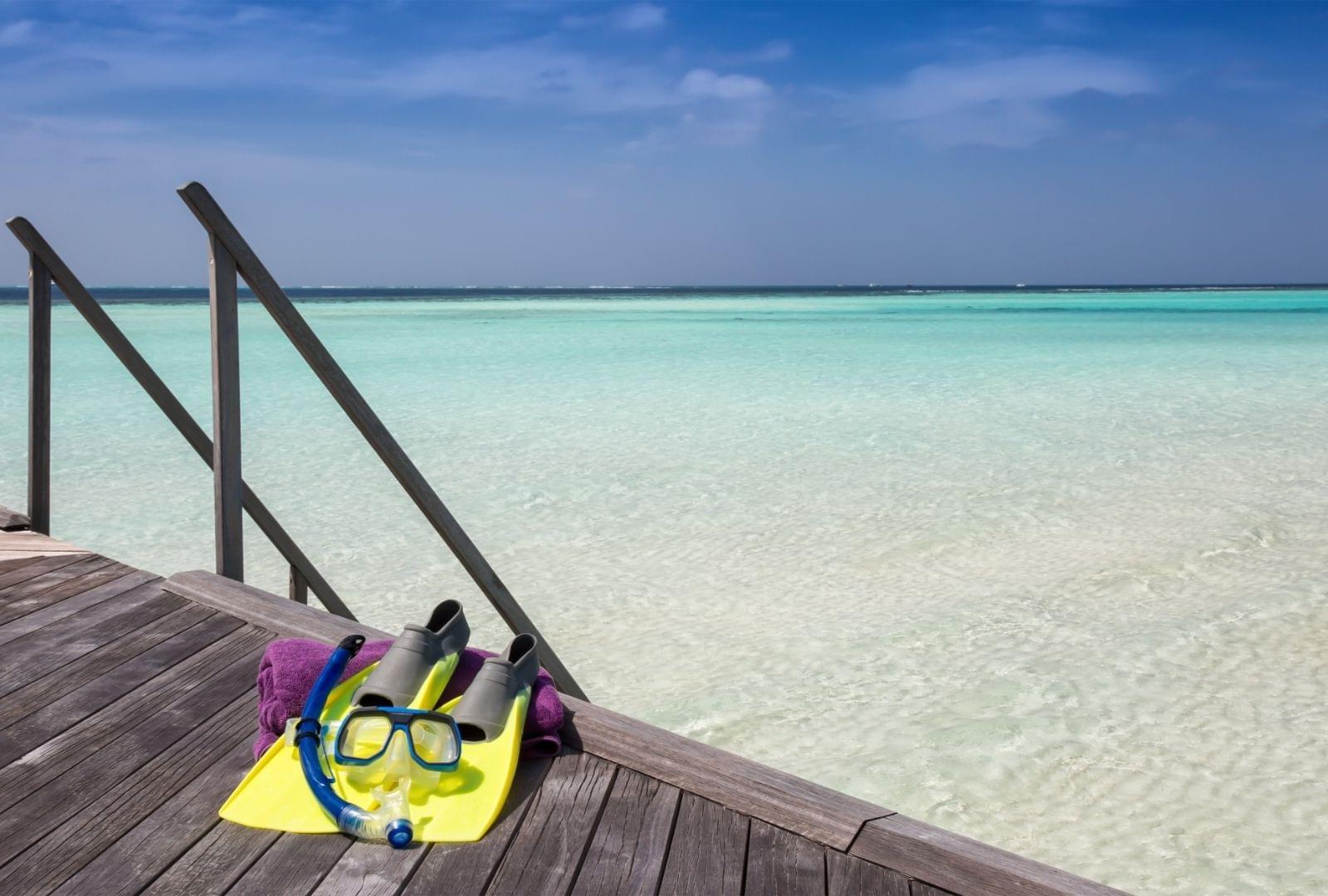 snorkel gear on a dock in tropical paradise