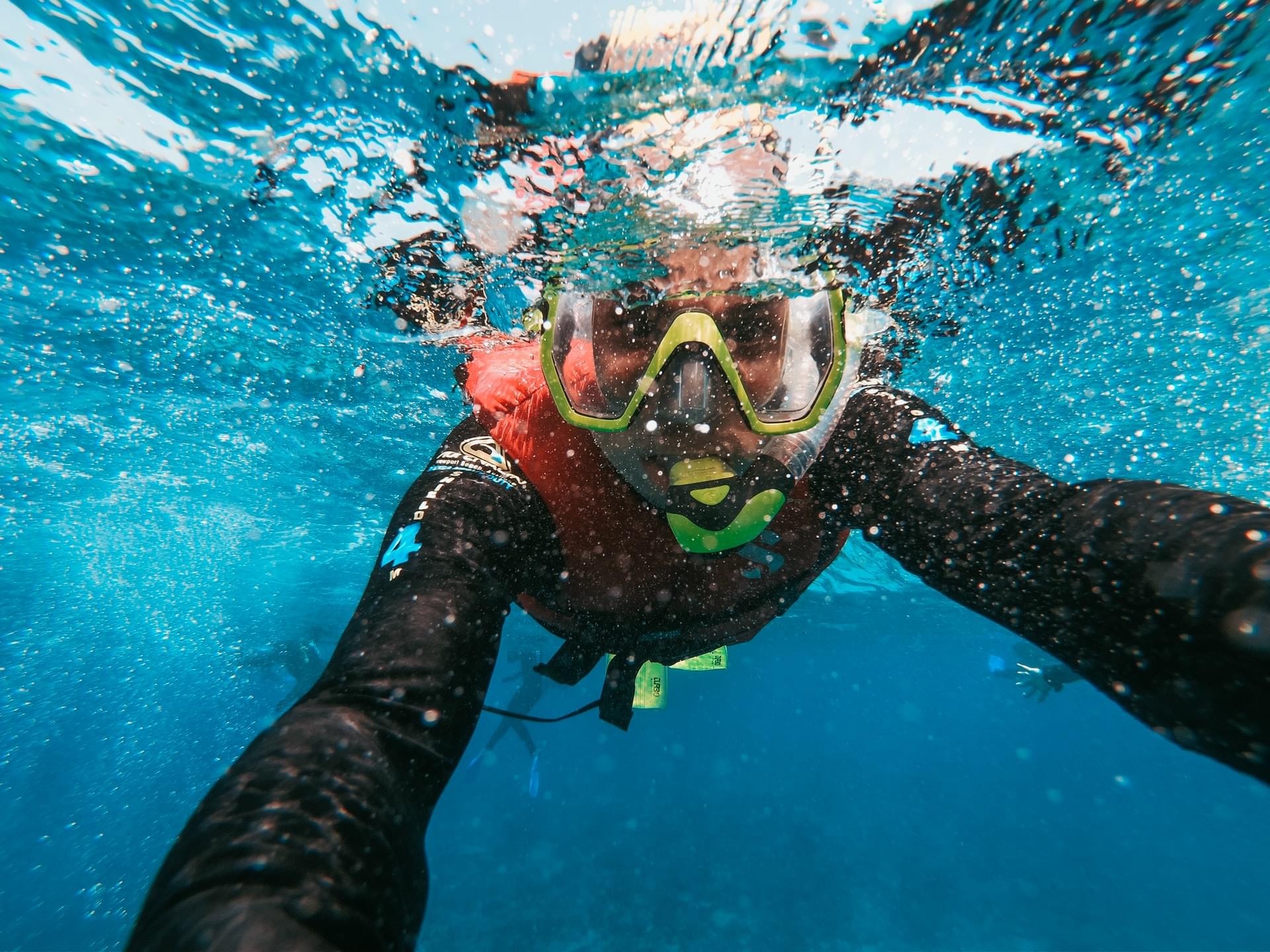 wearing life jacket snorkeling on surface